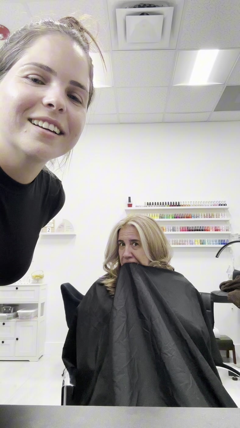 The stylist working and laughing with a client